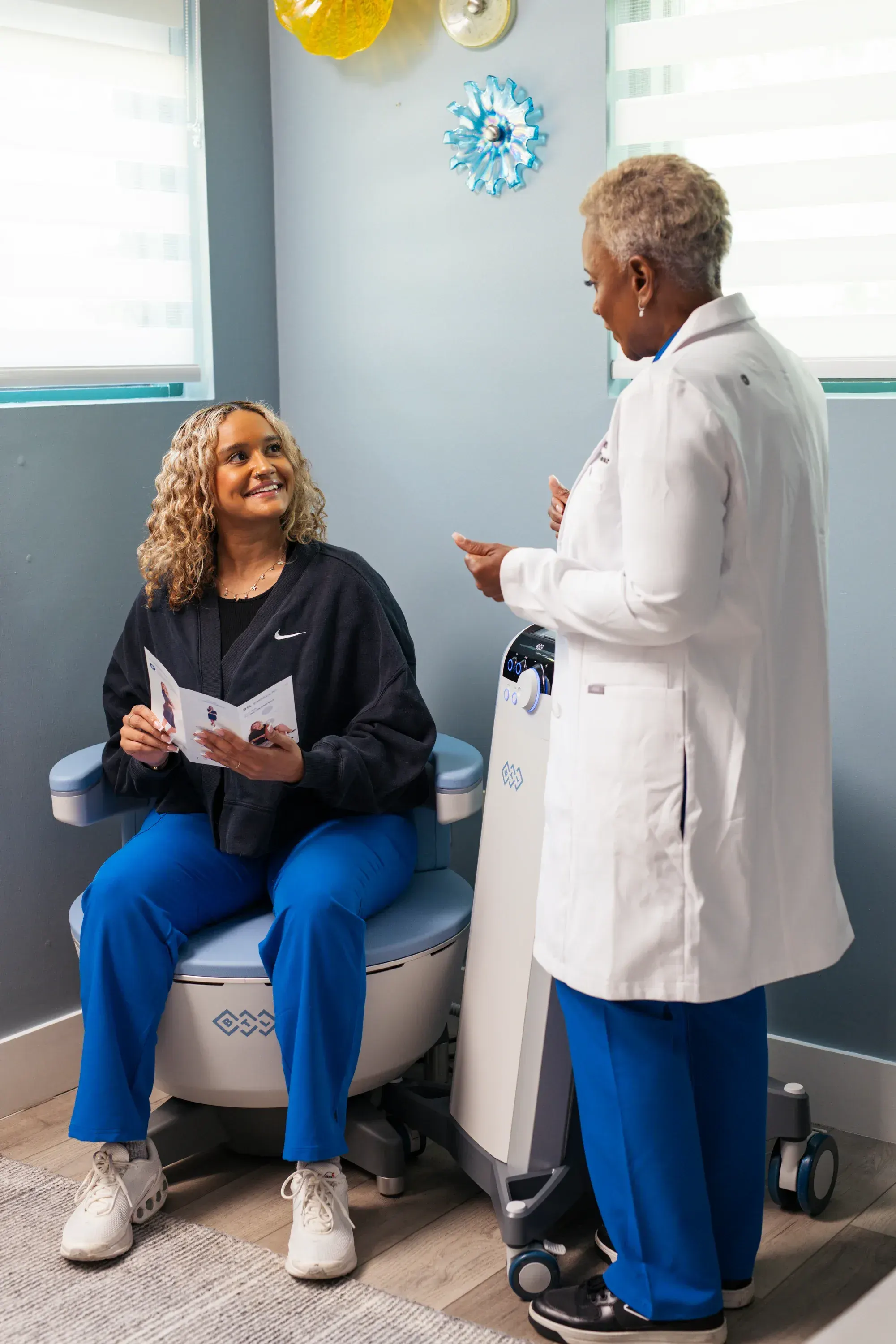 Patient consultation for Emsella therapy at Refresh TMS Weston